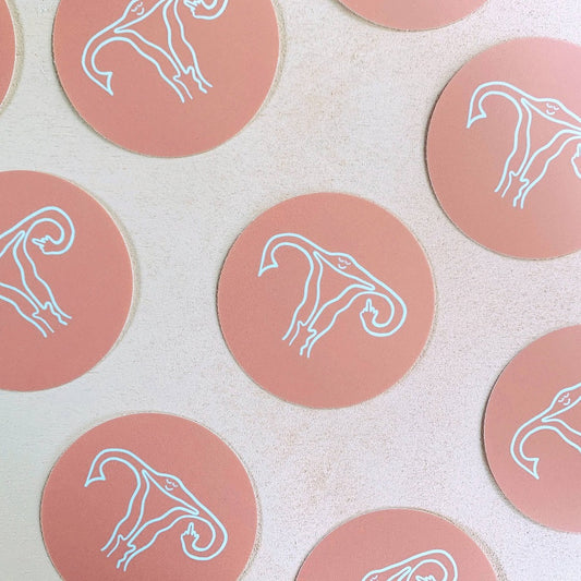 sassy uterus flipping the middle finger on a pretty salmon pink background waterproof decal